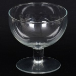 VIDRO, uma (1) taça bojuda de pé baixo, incolor e translúcida, bojo com inclinação, fuste quase cilíndrico, base em bolacha, medindo 15 cm altura e 13 cm diâmetro, vide foto.