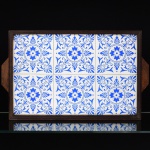 AZULEJOS, uma (1) bandeja retangular, ornamentação floral na tonalidade azul, possui rachados, borda de um dos azulejos quebrada, fixados sobre placa em Eucatex, moldura em jacarandá, medindo 52 x 32 cm, vide foto.