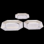 AÇO INOX, três (3) travessas octogonais de tamanhos distintos, confeccionadas na técnica de estamparia mecanizada, sem marca de manufatura aparente, medindo 34,5 x 22,5 cm; 42 x 27 cm e 46 x 30 cm, vide foto.