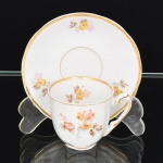 PORCELANA, uma (1) xícara de café, ornamentação floral policromada, arremates a ouro, marca  RIO BRANCO (Fábrica de porcelanas que estima-se o seu funcionamento entre 1947 e 1967 no Rio de Janeiro, de início como Companhia Brasileira de Vidros e posteriormente como Porcelana Rio Branco S/A; do ano de 1959 a 1965 a fabrica adotou um sistema de datação do mês e ano de fabricação, exemplos: 10.9 outubro/1959; 5.1 maio/1961, até o momento só existem peças com datação conhecida até o ano de 1965), datada a xícara de Abril de 1960 (4.0) e o pires de Outubro de 1960 (10.0), ideal para coleção de cristaleira, vide foto.