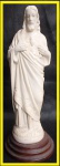 ESCULTURA - Escultura em resina sobre base de madeira, representando Sagrado Coração de Jesus. Altura=23,5cm.
