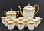 Limoges, France. Conjunto para café, composto de bule, açucareiro e 12 xícaras sem pires em porcelana esmaltada na cor branca com rica decoração em douração, composta por faixa ornamental de inspiração neoclássica, formada por reservas ovais com motivos florais estilizados, folhagens e arabescos, dispostos em composição rítmica e simétrica. Apresenta frisos e filetes concêntricos em ouro, acabamento de grande elegância e requinte. Manufatura no verso. Medindo: 29 x 24 cm e 14 x 18 cm. Uma xícara com bicado.
