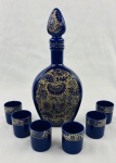 Veracruz. Conjunto composto por licoreira e seis copinhos, em porcelana de tonalidade azul-cobalto, decorados em azul e branco com motivos florais e folhagens, apresentando composição ornamental de inspiração oriental. Medindo a licoreira: 29 x 12 cm e os copinhos: 5,5 x 4,5 cm.