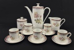 Real. Conjunto para café em porcelana nacional esmaltada, na cor branca, faixa vinho, decoração floral e rica douração. Composto de bule, leiteira, açucareiro e 5 xícaras com seus pires. Manufatura no verso. Medindo; 19 x 19 cm, 8,5 x 12 x 7 cm, 9 x 7,5 cm.