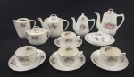 Conjunto de peças em porcelana esmaltada e policromada, decoração floral e filetes em ouro, mesma manufatura, porém modelos e tonalidades diferentes. Composto de 3 bules, 1 leiteira sem tampa, açucareiro, manteigueira, 4 xícaras com seus pires. Medindo respectivamente: 17 x 16 cm, 14 x 14 cm, 14 x 19 cm, 11 x 12 cm, 10 x 14 cm e 9 x 15,5 cm. 3 com fios de cabelo, um bule com bicado no bico, um bule com pequeno restauro na borda e leiteira com discreto bicado interno.