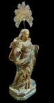 Antiga imagem sacra em madeira entalhada e policromada, com vestígios de outo, . Acompanha resplendor em metal com decoração em relevo e raios. Apresenta perdas na policromia e falta das mãos. Medidas: imagem 21,5 x 9,2 x 6,5 cm; coroa 7,5 x 7,2 cm.