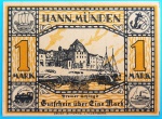 Alemanha (Hann. Münden), 1922. Cédula de emergência (Notgeld) de 1 Mark, emitida pelo conselho municipal da histórica cidade de Hannoversch Münden. O anverso celebra a famosa confluência geográfica local com o célebre poema do Weserstein: "Onde o Werra e o Fulda se beijam...", ilustrando o ponto exato onde os dois rios se unem para formar o Rio Weser. O reverso exibe uma bela vista portuária da cidade (Bremer Schlagd), emoldurada por quatro medalhões nos cantos que representam a infraestrutura e o comércio locais: um navio mercante, uma âncora com barril, uma locomotiva a vapor e uma antiga roda d'água. Uma peça lindamente contextualizada, impressa pela prestigiada Schwarz de Lindenberg, unindo simbolismo natural e orgulho logístico do período Weimar