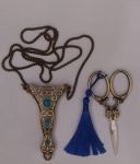 COLECIONISMO - Tesoura colecionável em aço inoxidável, no mais puro estilo vintage com suporte do mesmo material lindamente adornado com decoração na cor turquesa e cordão que possibilita usar a mesma no pescoço; a tesourinha possui o cabo bronzeado. Medindo com o suporte 10 cm de comprimento e o cordão fechado mede 40 cm.