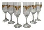 Conjunto de taças decoradasConjunto com 6 taças em vidro para espumante, decoradas com friso dourado e delicado motivo de laços, sobre fundo com padronagem sutil gravada. Peças elegantes, adequadas para champanhe ou espumante, de produção do século XX. Bom estado geral, com leves sinais de uso compatíveis com a idade. Mede 18,5 cm.
