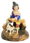SÉVRES FRANÇA - Grupo escultórico "flautista com cão", em porcelana francesa de Sévres com farta policromia. Meados séc. XIX. Mede 16 x 12,5cm.