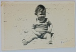 Foto Postal Original (1946) Bebê na Praia de Muizenberg, África do Sul  Identificado Aspectos visuais (Frente): terno e expressivo retrato em preto e branco mostrando um bebê sorridente sentado diretamente na areia da praia. No canto inferior direito da imagem, há uma assinatura ou iniciais manuscritas à caneta: "S. W. Smidt". Riquíssimos Detalhes do Verso (Identificação Completa): O verso em formato postal (não circulado) traz anotações detalhadas a caneta em inglês que identificam a criança, o local e o destinatário: Nome da Criança: "Stanley-Woodrow Smidt"
