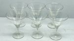 DEMI CRISTAL - Lote com Seis Taças em Demi Cristal Transparente Trabalhado com Lapidação de Folhagens/Ramos - Conjunto composto por seis taças em demi cristal transparente de cálice cônico, haste delicada e base circular plana. O bojo é finamente decorado com lapidação em relevo (fosca) formando motivos que remetem a ramos ou folhas dispostos simetricamente, complementados por finas linhas horizontais gravadas na parte inferior.
