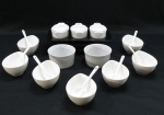 Lote composto por 20 peças em porcelana branca , composto por sete graciosas molheiras ovaladas ( 4 x 10 x 7 cm) sete colheres, dois ramequines ( 9 cm diâm) e conjunto com três molheiras apoiadas sobre bandeja na cor preta