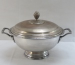 WOLFF - Uma (1) sopeira em metal espessurado à prata padrão laço de fita, em formato côncavo, alças vazadas e modeladas em folhas, pega da tampa em forma de fruto, ornamentada. Medidas 32x25 cm. Tampa necessita prateação.
