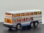 Miniatura die-cast do autocarro turístico de dois andares Neoplan Bus Skyliner (série estrangeira Tomica, modelo No. F37, escala 1/154), fabricado no Japão. Apresenta esquema de pintura em branco com faixas laterais azuis, inscrições "Skyliner" e "Paris Vision", janelas panorâmicas com vidros âmbar/amarelados revelando o interior detalhado de dois pisos, para-choques e grelhas pretas, matrícula traseira "TN792", chassi inferior em metal/plástico gravado com as especificações do fabricante e escala, acompanhado da respetiva caixa de cartão original Tomica ("Foreign Car Series"). Com marcas de tempo de uso.