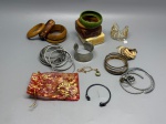 Lote composto por diversas pulseiras de materiais e modelos variados. Incluem: argolas em metal na cor prateada com textura trançada e lisa; bracelete tipo manchete em metal prateado com acabamento martelado; bracelete rígido em metal escuro com esferas nas extremidades; pulseiras em resina/baquelite nas cores marrom, verde e creme; bracelete filigranado em metal dourado; conjunto de pulseiras em metal dourado e envelhecido; bracelete em cordão trançado com detalhes metálicos; colar com pingente em pedra verde; e sachê decorativo em tecido. Materiais, marcas e autoria não identificados. Estado geral de uso. Vendido no estado. bangles, adornos, conjunto, escrava, tornozeleira, filigrana, arco