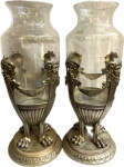 WMF - Germany - Antigo par de Vasos em metal espessurado a prata decorado com Figuras de Rostos Mitológicos e pésde garras, e recipiente em vidro, peçasmarcadas. Med. 41 X 18 cm.