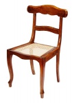 Antiga cadeira pernambucana em madeira nobre na cor castanho. Assento em bom estado com palha sintética.
