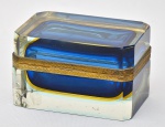 Elegante porta joias europeu confeccionado em grosso cristal translúcido, âmbar e azul, com guarnição em bronze ormolu cinzelado. Med.: 8,3x13x8,3 cm. Obs.: apresenta dois lascados na base.