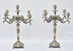 PRATA - Par de magníficos candelabros portugueses confeccionados em prata baixa (500 mls) ricamente cinzelada,  apresentando rica decoração floral em relevo, para cinco velas cada, com braços recurvos adornados com cachos de uva e folhas de parreira, apoiados sobre quatro pés em garra. Peças para colecionadores. Med.: 53x45 cm.  Peso total: 8.120 gramas (8,1 Kg.).