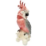 Escultura em porcelana alemã, kARLS ENS, Volksted, representando cacatua pousada sobre tronco, com bela e fina plumagem, nas cores rosa e cinza. Altura: 29 cm.(uma ponta do penacho com imperceptivel restauro)