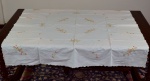 Toalha de mesa em tecido de cambraia de linho com bordados cheios coloridos nos tons laranja e verde. Possuem oito guardanapos. Marcas de uso. No estado.  Medidas: 152,0 cm  X  148,0 cm.   27,0 cm  X  27,0 cm. ( guardanapos ).