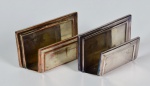 Dois porta - guardanapos em metal prateado. no estado - med. 6,0 cm x 10,0 cm x 2,5 cm ( um deles com perda do banho de prata)