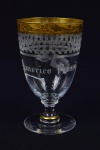 Taça de coleção em fino cristal europeu gravado. Borda com faixa em ouro.  Inscrições " Américo Rossi".Med. 12,5 cm x 7,5 cm . Marcas de uso. No estado. Coleção Particular Rio de janeiro - RJ.