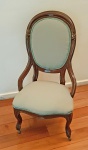 Antiga cadeira baixa inglesa, estilo vitoriano, em madeira de lei, com rodas e estofado verde em ótimo estado. Encosto levemente côncavo. Alt. 110 cm