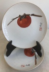 COLEÇÃO - Par de belíssimos pratos de fina porcelana oriental, decorados com caqui, guarnições pintadas em ouro. Med. 15cm de diâmetro, cada.