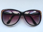 Antigo óculos feminino para sol na cor preta com apliques em vermelho e dourado. Lentes fumê.