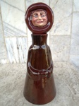 Garrafa  em forma de FREIRA em cerâmica esmaltada e vitrificada no tom marrom forte , com tampa na forma de rosto. Altura 31 cm