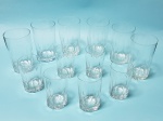 Conjunto de 12 copos de demi-cristal, estilo dedão, em 2 tamanhos:. 6 copos com 10 cm de altura (um com pequeno bicado na borda) e 6 copos com 7 cm de altura (um com pequeno bicado na borda).