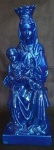 Grupo escultórico em estuque laqueado no padrão Azul representando Nossa Senhora do Carmo sentada com criança no colo.  Alt.= 28cm.