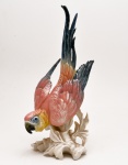 Escultura em porcelana alemã policromada, representando figura de `pássaro`. Marcas no verso. ENS. Alemanha. C. 1920. 34 cm.